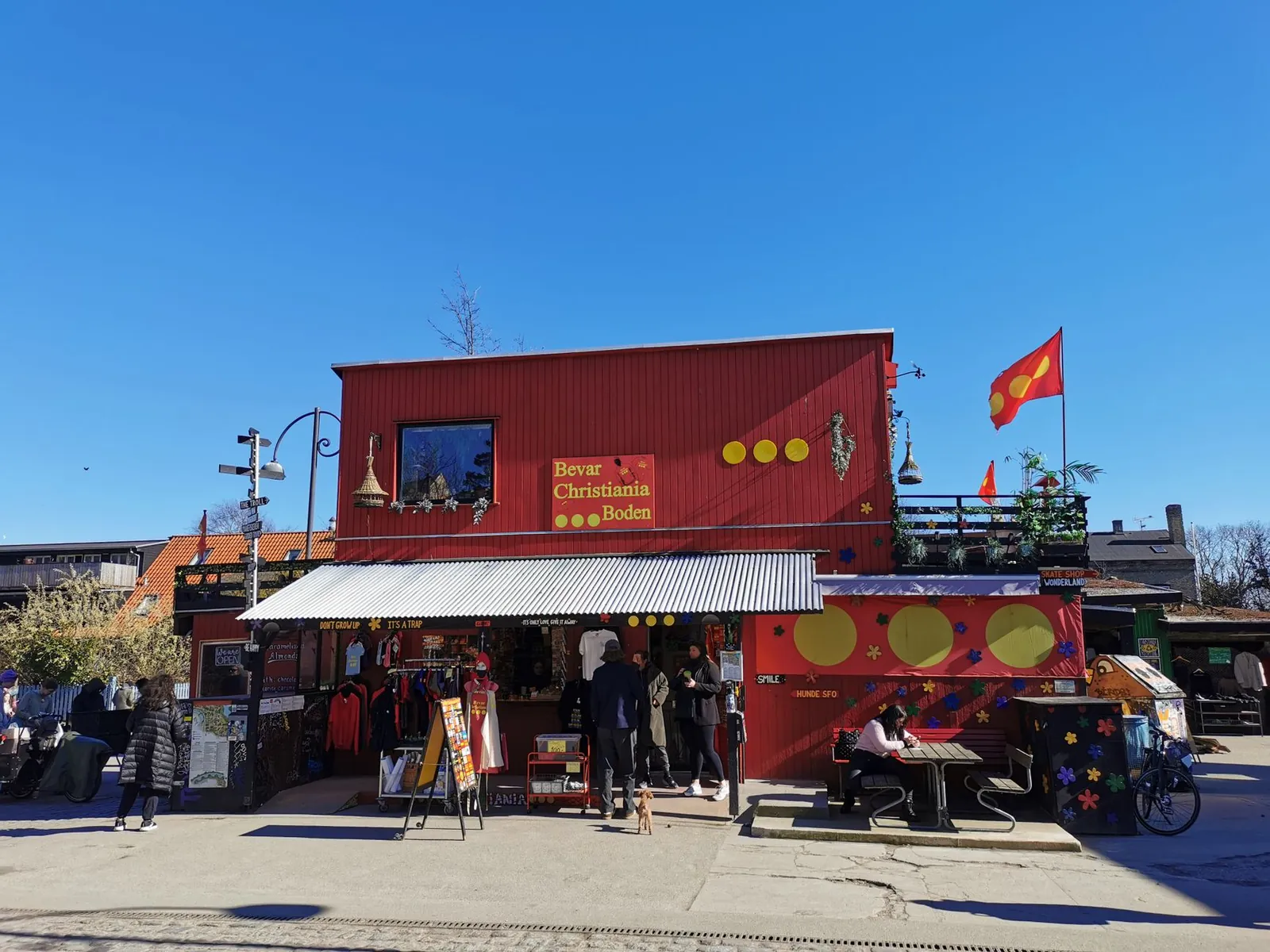 Shops and the Christiania flag flying in Freetown Christiania, Copenhagen