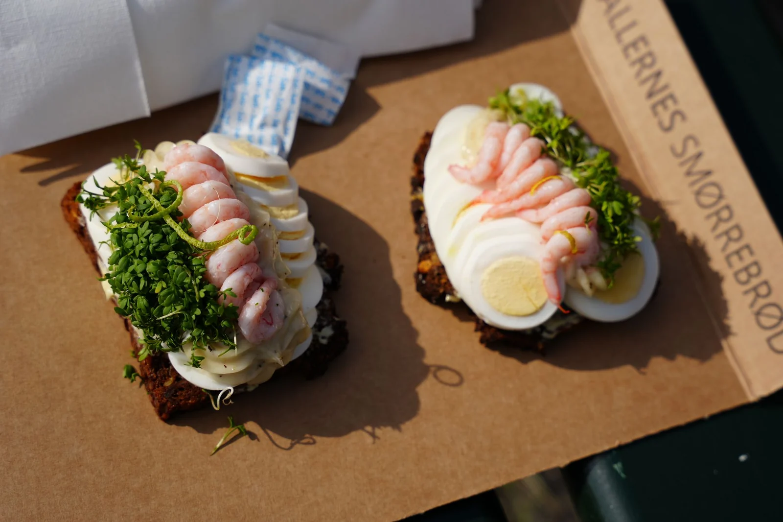 Two pieces of Danish smorrebrod with shrimp and egg from a Copenhagen market hall