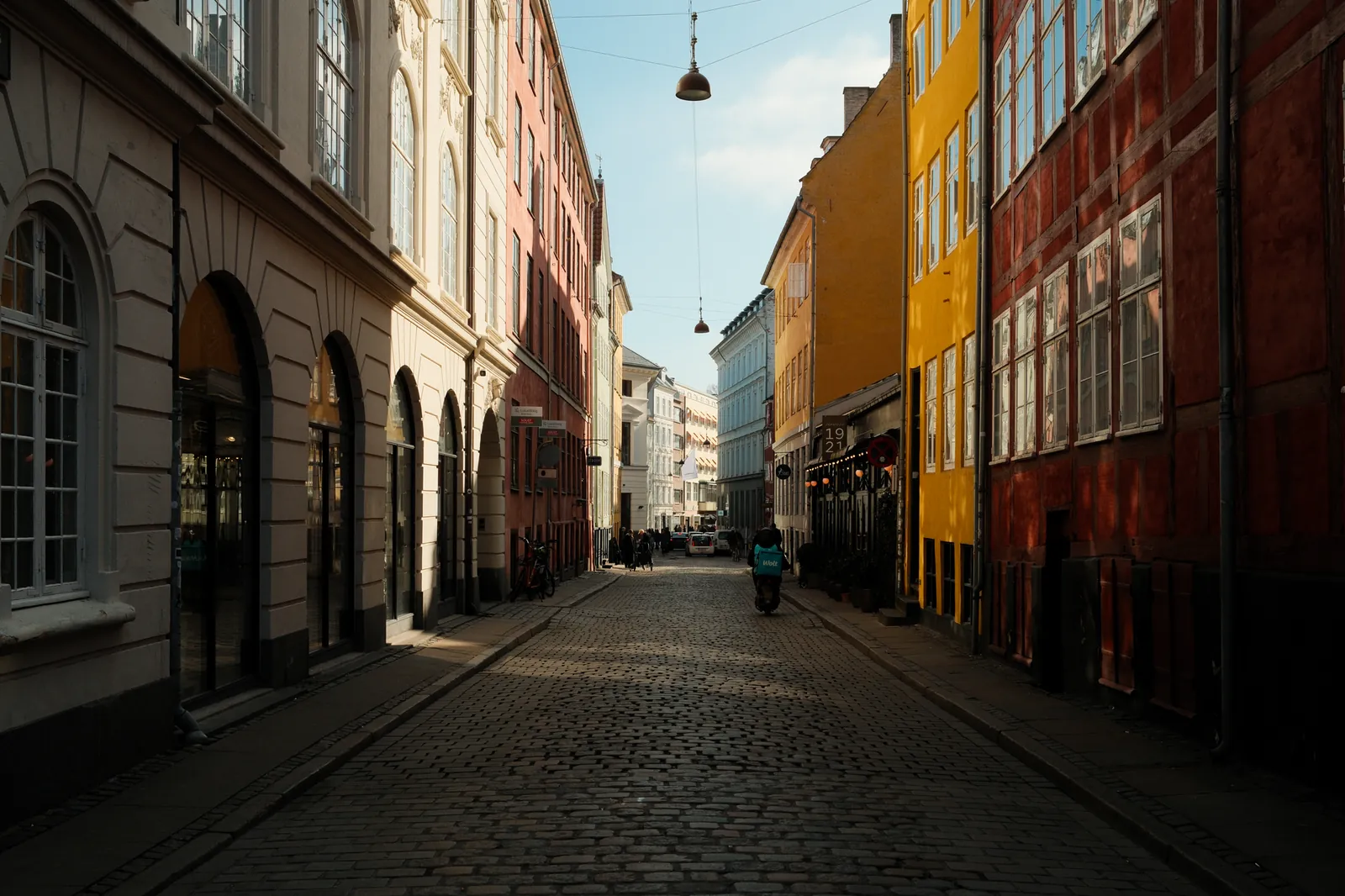 A cobbled Copenhagen side street of the kind that hides the city cocktail bars