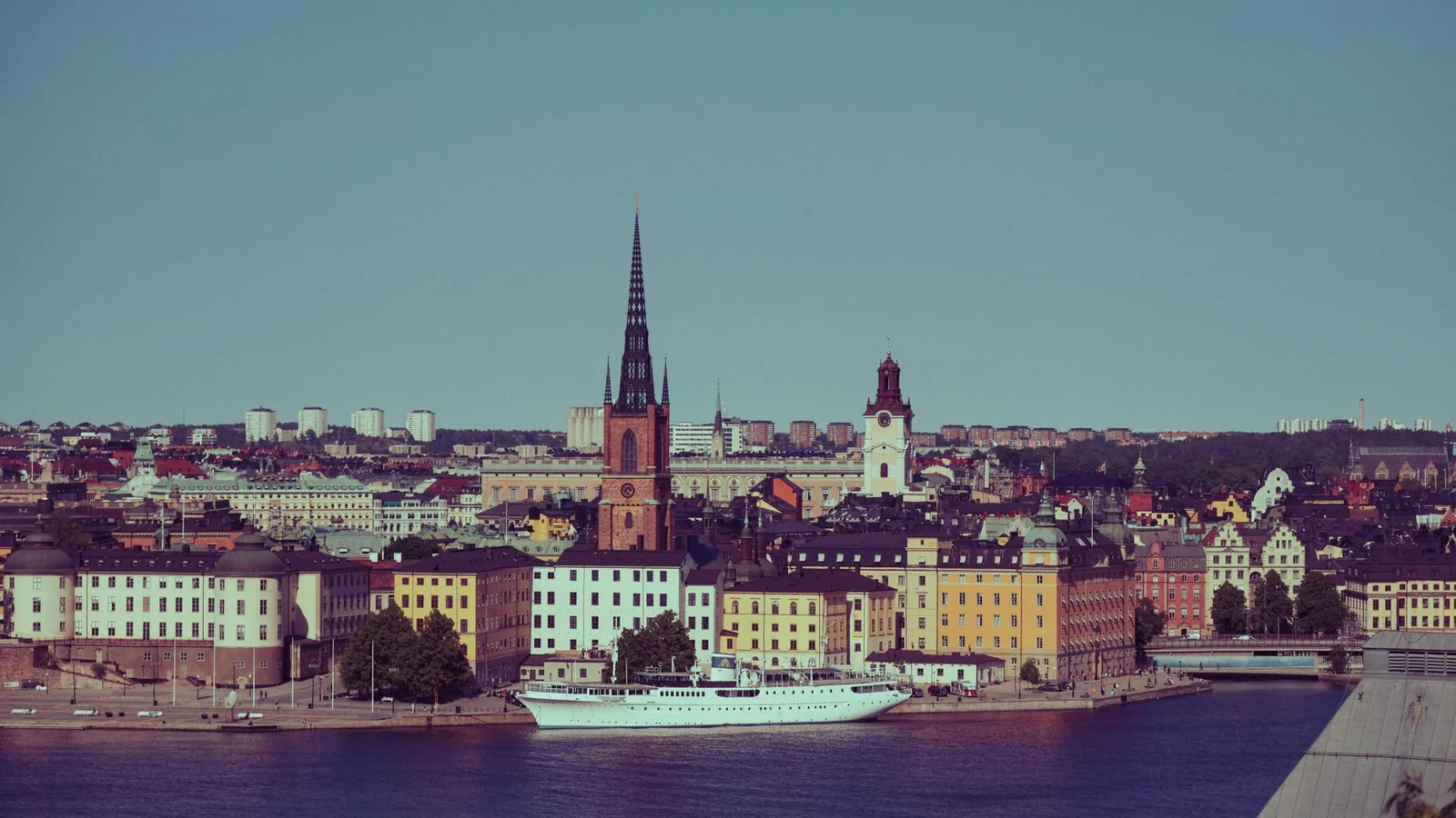 Stockholm's old town and the spire of Riddarholmen Church seen across the water on a sunny day