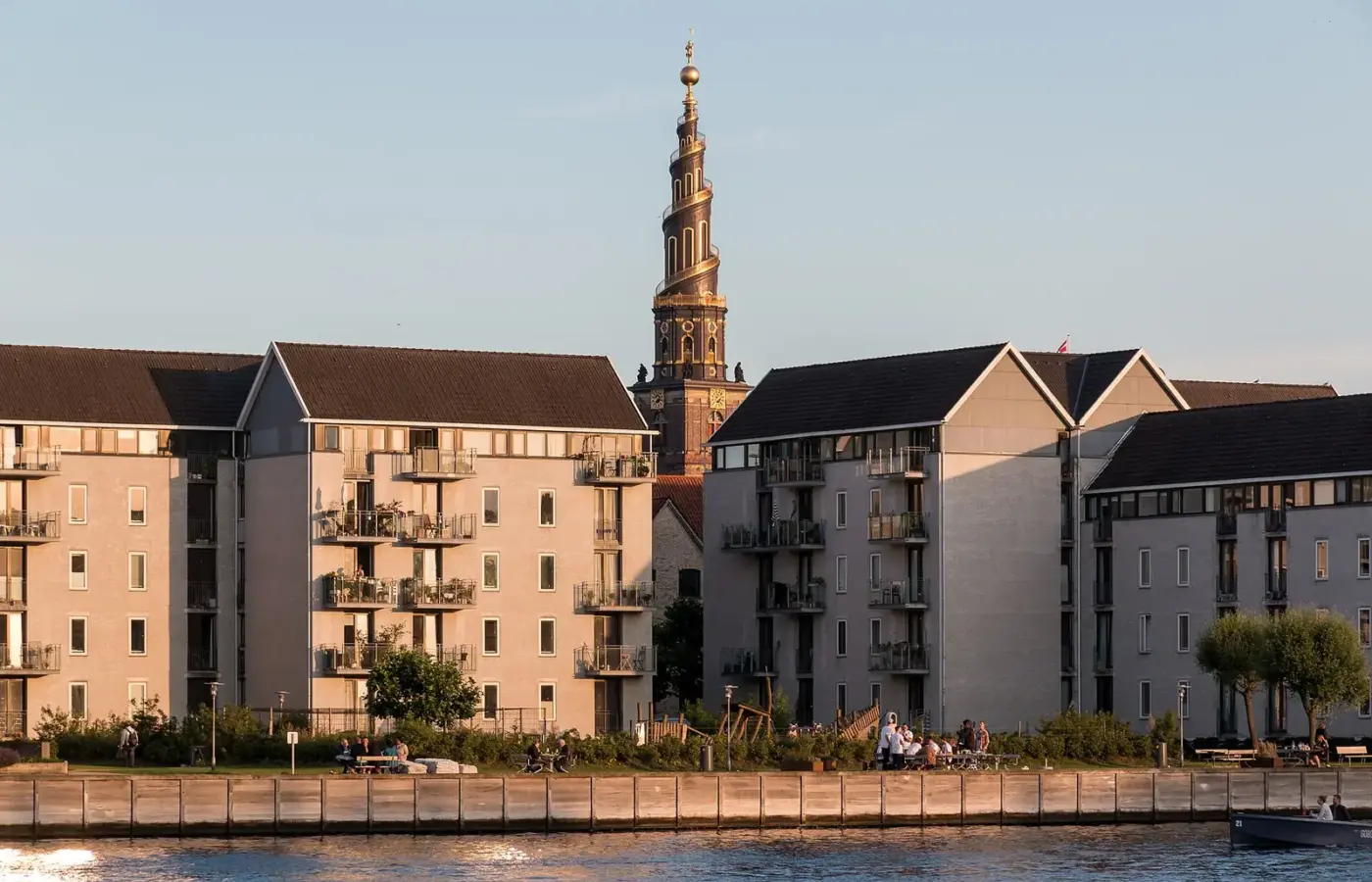 The golden spiral spire of the Church of Our Saviour rising above Christianshavn at sunset