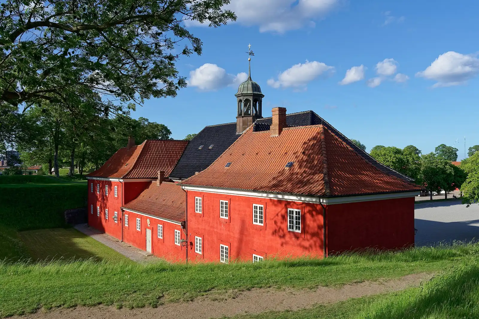 The red prison building attached to the back of Kastellet's church, with the church's copper bell turret above