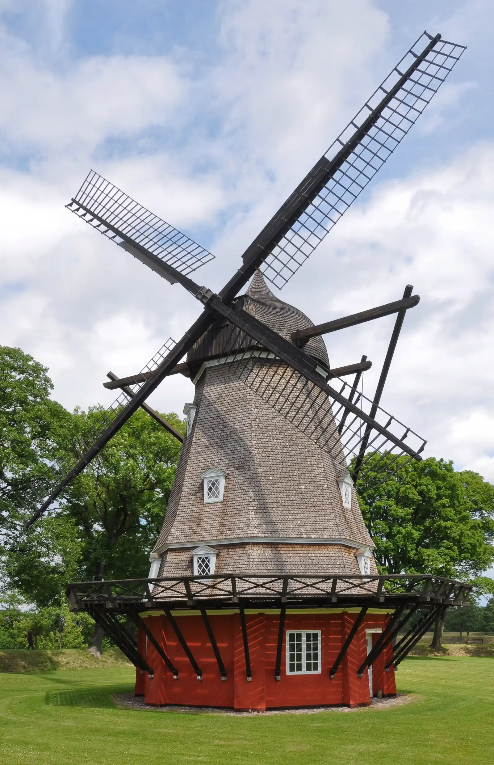 Kastellet's Dutch-style windmill from 1847, with a shingled cap and red base, standing on the King's Bastion
